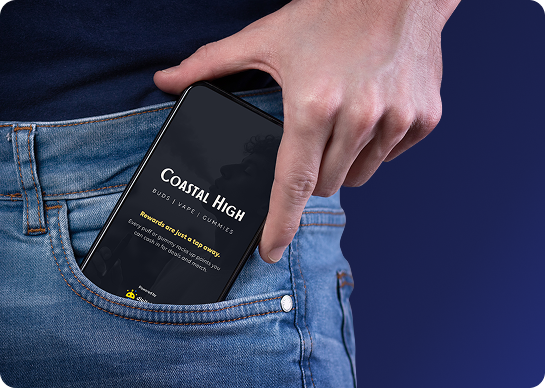 A hand holding a phone with the brand app
